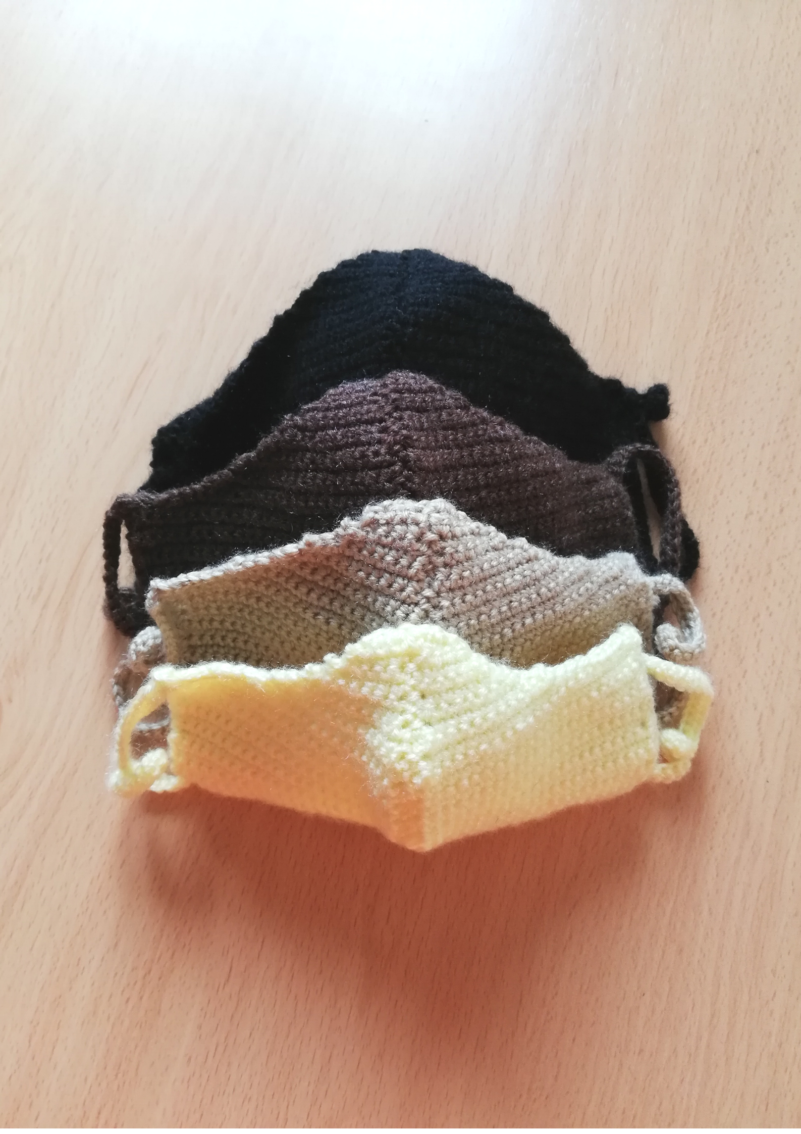 yellow crochet face mask children-sized 3-6 years old; light brown crochet face mask children-sized 7-12 years old; brown crochet face mask women and teen-sized; black crochet face mask men-sized